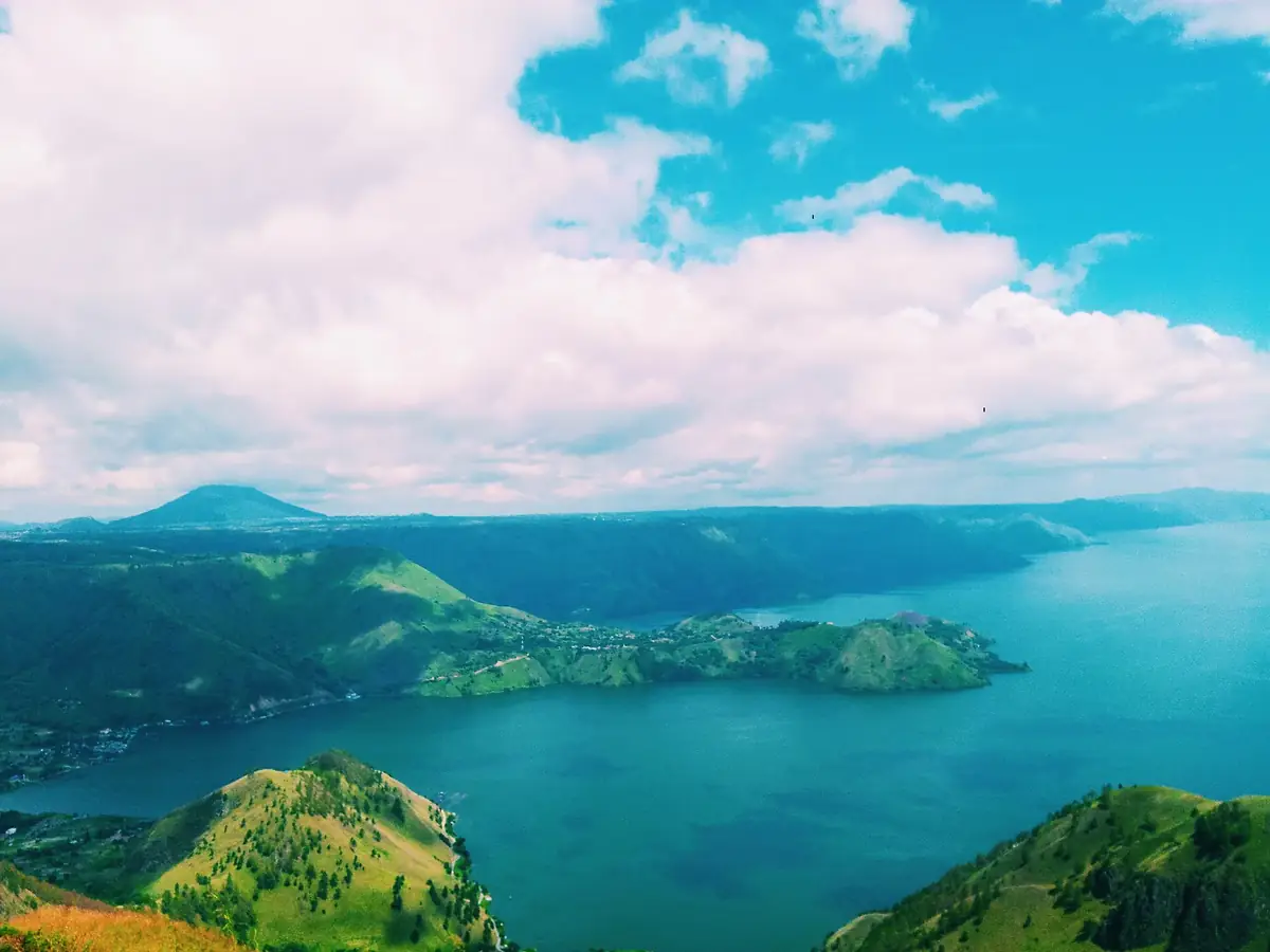 Blick aus der Höhe über den Tobasee mit grünen Hügeln auf Sumatra